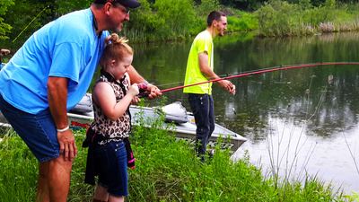 A family fishing from the dock